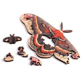 The Mini Moth Wood Puzzle by Nervous System showcases intricately designed jigsaw pieces, featuring a beautifully detailed moth and smaller puzzle fragments. This wooden puzzle combines art and play, making it a great gift for puzzle enthusiasts and nature lovers alike.