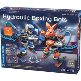 The Hydrolic Boxing Bots DIY kit by Thames & Kosmos, featuring a colorful box design. The image displays two hydraulic boxing robots, one gray and blue, the other orange and brown, positioned in a boxing stance with visible hydraulic controls. The box highlights key features like 'Let's Rumble!', 'Ultra-Responsive Hydraulic Controls', and is suitable for ages 10 and up. It includes 327 pieces for a challenging build.