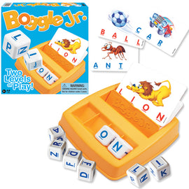 Boggle Jr. game by Winning Moves featuring an orange game tray, letter cubes, and illustrated word cards. Game elements include a soccer ball, car, ant, and lion, promoting word recognition and spelling skills for young children. The box design highlights 'Two Levels of Play' for engaging gameplay.