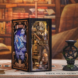 The Nebula Common Room Book Nook by Tonecheer depicts an intricately designed miniature room filled with books, magical elements, and whimsical characters. The scene includes a cozy reading area with charming details, such as a staircase, a bookshelf, and decorative accents, making it an enchanting addition to any bookshelf or display.