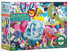Eeboo's Magical Creatures jigsaw puzzle featuring vibrant illustrations of mythical animals including a unicorn, a dragon, and a pensive lion. The colorful design is adorned with whimsical flora and fauna, making it ideal for children ages 3 and up. The packaging boasts eco-friendly materials and highlights that it's a woman-owned business based in New York City.