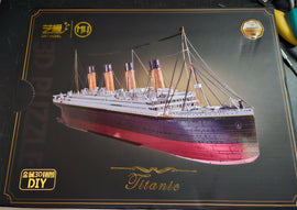 Mu Model Titanic DIY kit featuring a detailed 3D model of the famous ocean liner. The box displays the Titanic's iconic design, including its smokestacks and deck details, perfect for model enthusiasts and DIY lovers.