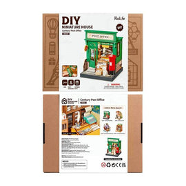 The Century Post Office DIY kit by Robotime is displayed, featuring a vibrant green post office facade with details like a red mailbox and stacked packages. The kit includes components for building a miniature house, perfect for ages 14 and up.