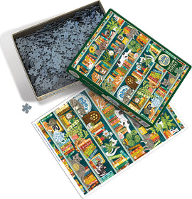 The Purrfect Bookshelf jigsaw puzzle by Cobble Hill, featuring a vibrant image of a cozy library filled with colorful books and playful cats. The puzzle box is open, revealing many jigsaw pieces and an illustrated reference image of the completed puzzle.