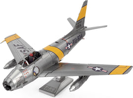 Metal Earth F-86 Sabre metal model kit by Fascinations, showcasing intricate details and realistic design. The model features a silver body with yellow and black accents, including military insignias. Ideal for enthusiasts of aircraft and DIY projects.