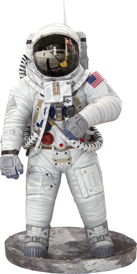 A detailed model of an Apollo 11 astronaut, showcasing intricate design elements such as the helmet's reflective visor, the American flag patch, and various equipment. The astronaut stands on a lunar-like base, embodying the spirit of space exploration.