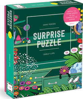 The Shelf Life Surprise Puzzle by Galison features a vibrant design with 1000 pieces showcasing colorful plants and flowers. The puzzle box emphasizes the fun of watching the scene emerge as it is completed.