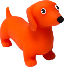 A bright orange rubber dachshund dog toy from the Strechi Dogs collection by INcredible. The toy features large expressive eyes and a playful stance, perfect for kids and dog lovers alike.
