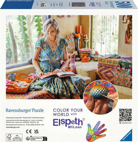 The Elspeth McLean: Magnificent Ma jigsaw puzzle by Ravensburger features a creative scene with a woman in a colorful dress sitting on a couch, reading a book surrounded by vibrant decor and artistic patterns. The packaging displays intricate designs, showcasing the artistic theme of the puzzle.