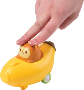 A playful child’s hand is shown pressing down on the Press and Go Banana Car toy. The toy features a cheerful monkey character sitting in a vibrant yellow banana-shaped car with wheels. The interactive design allows for fun playtime as the car moves forward when pressed.