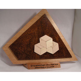 A beautifully crafted 3D Puz Pyramid made by O'Shea's Magic, featuring three cubes arranged in a triangular formation. The puzzle has a wooden base with a sleek finish, accentuating the contrast between the light and dark wood tones. It showcases intricate detailing, perfect for puzzle enthusiasts and collectors alike.