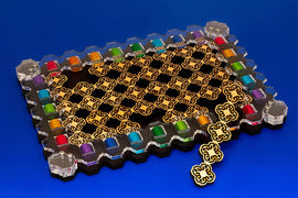 The Orient Elox mechanical puzzle by Jean-Claude Constantin features a unique design with colorful pieces arranged around a central intricate pattern. The vibrant colors and geometrical shapes create a visually appealing layout, perfect for puzzle enthusiasts seeking a challenging experience.