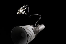 A detailed representation of the Gemini spacecraft, showcasing its sleek design with an astronaut performing a spacewalk attached by a safety tether, set against a black background. The image highlights the intricacies of the spacecraft's shape and texture, enhancing its appeal for space enthusiasts and model builders.