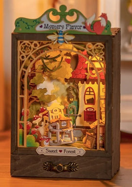 The 'Sweet Forest' DIY kit by Robotime features a beautifully detailed miniature scene, complete with a charming house, vibrant foliage, and whimsical decorations. The kit lights up, creating a warm ambiance and showcasing intricate craftsmanship, making it a delightful project for hobbyists and craft lovers alike.