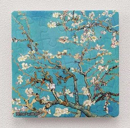 A 16-piece jigsaw puzzle magnet featuring Vincent van Gogh's artwork 'Almond Blossom.' The image showcases delicate white blossoms against a vibrant blue background, capturing the essence of spring. Perfect for art lovers and puzzle enthusiasts, this magnet adds an elegant touch to your fridge or workspace.