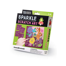 The Sparkle Garden Scratch Art kit by Crocodile Creek, featuring 15 colorful scratch sheets showcasing vibrant floral and animal designs. Ideal for creative play, it includes a wooden stylus for revealing hidden artwork. Recommended for ages 5 and up, the packaging highlights caution about small parts for younger children.
