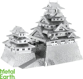 A detailed metallic model of Osaka Castle, featuring intricate architectural elements and multiple tiers. The model displays a mix of traditional Japanese style with layered roofs and large base, showcasing craftsmanship and design. Ideal for DIY enthusiasts and collectors.