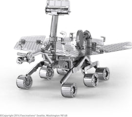 A detailed metal model of the Mars Rover, designed by Fascinations. The intricate structure showcases various components including solar panels, antennas, and wheels, all crafted from shiny metal for a modern look. This DIY kit allows enthusiasts to build their own replica of this iconic space exploration vehicle.