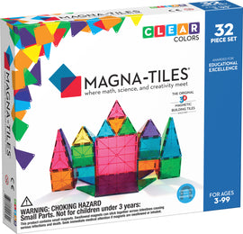 Magna Tiles Clear Colors 32 Piece Set, featuring colorful, translucent magnetic building tiles arranged to form a castle. The box showcases the product's educational focus on math, science, and creativity, perfect for ages 3 to 99.