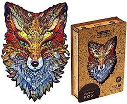 A finished jigsaw next to its box. The puzzle is of a fox and is shaped like the fox's head
