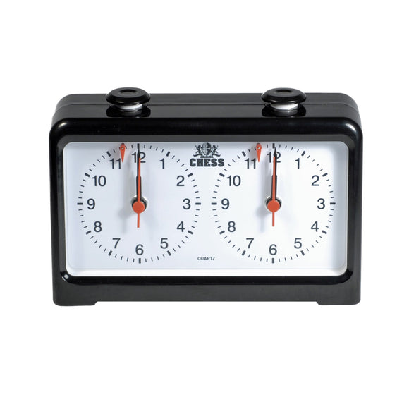A classic analog chess clock displayed with two large white dials. Each dial shows numbers from 1 to 12, with red hands indicating the time. The black plastic casing adds a sleek touch, making it a perfect accessory for any chess game.