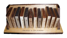 Dewey's Dilemma is a mechanical puzzle featuring a wooden base with numbered blocks arranged in a row. Each block is crafted from different types of wood, showcasing a rich color variation. The puzzle challenges users to arrange the blocks in a specific order, enhancing problem-solving skills and providing a tactile experience. The wooden base is engraved with the product name, adding a touch of elegance to this captivating brain teaser.