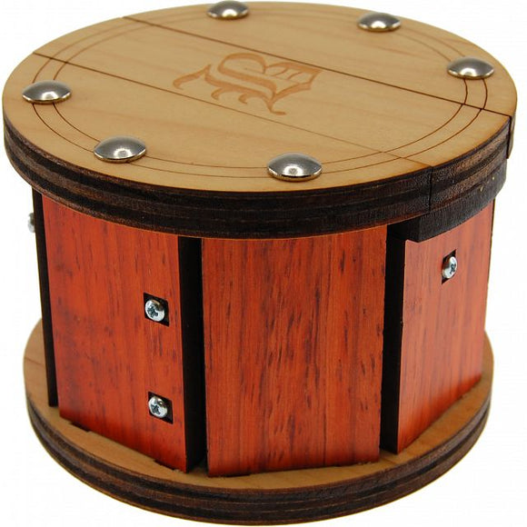 The Beebox is a beautifully crafted mechanical puzzle featuring a round shape with a polished wooden top and sides. The design incorporates several intricately placed screws and grooves, showcasing an elegant mix of light and dark wood tones. This puzzle is engaging and visually appealing, challenging users to unlock its secrets through mechanical manipulation.