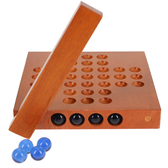 Handheld wooden solitaire game by Wood Expressions. The game features a smooth, polished wooden board with drilled holes arranged in a grid. Several black and blue marbles are placed around the board, ready for play. The wooden peg is shown positioned above the game, indicating the gameplay mechanics.