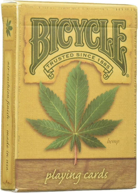 A deck of Hemp Playing Cards by US Playing Card Co., featuring a vibrant green hemp leaf design on the front. The packaging highlights its eco-friendly composition and traditional craftsmanship, with the iconic Bicycle logo prominently displayed.