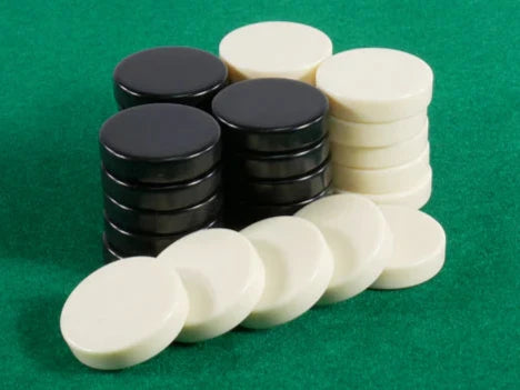 Checkers game set featuring 12 black and 12 ivory circular pieces, each measuring 1.5 inches in diameter. The checkers are displayed on a green felt background, showcasing their smooth finish and classic design. Ideal for family game nights and strategic play.