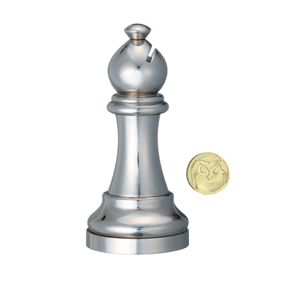 A sleek metallic Bishop chess piece puzzle by Hanayama, showcasing a polished finish and unique design. Next to it sits a small gold coin with an owl emblem, adding a classic touch to this mechanical puzzle.