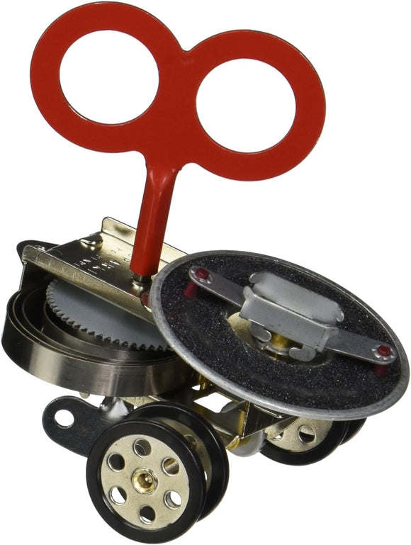 A detailed image of the Sparklz Wind Up Bot, a whimsical mechanical toy designed by Kikkerland Design Inc. The bot features a distinctive red wind-up key and a metallic body with intricate gears and wheels, showcasing a playful design perfect for collectors and kids alike.