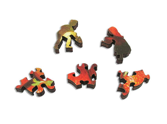 A variety of wooden jigsaw puzzle pieces featuring vibrant strawberry imagery. Each piece shows intricate designs and colors, highlighting playful figures and fruit details.