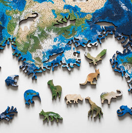 The Earth Puzzle by Nervous System features intricately designed jigsaw pieces shaped like animals and ocean life, set against a map of the Earth. The pieces include colorful representations of various wildlife and marine creatures, highlighting the beauty of nature and biodiversity. Ideal for puzzle enthusiasts, this engaging design invites players to explore the globe while assembling the vibrant colors and forms.