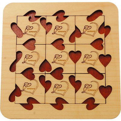 A beautifully crafted mechanical puzzle, titled 'L'amour', featuring intricately designed wooden pieces shaped like hearts. The puzzle is made by Jean-Claude Constantin and combines aesthetic appeal with mental challenge, offering an engaging activity for puzzle enthusiasts.