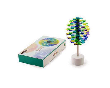 Lollipopter Sugar Plum Solid by Beyond 123, a colorful and vibrant decorative spinning toy composed of layered discs and a sturdy base, presented in a stylish box. The toy, in hues of blue, green, and purple, spins gracefully and captivates attention.