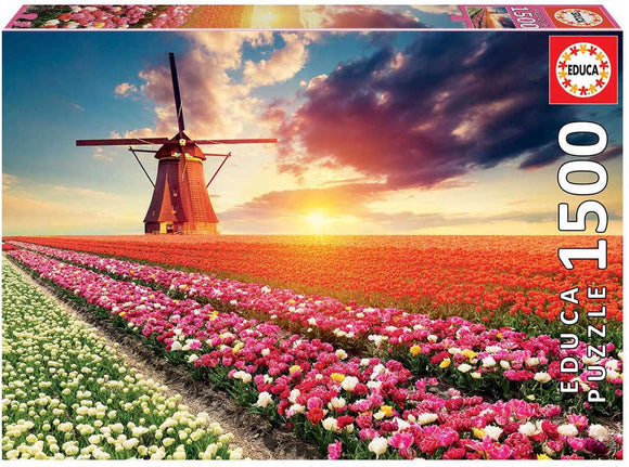 Educa 1500-piece jigsaw puzzle featuring a vibrant landscape of colorful tulip fields in bloom, with a traditional windmill and a picturesque sunset sky.