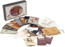 Escape the Starline Express game box by Professor Puzzle featuring an assortment of themed cards, notes, and envelopes spread around it, designed for immersive gameplay with mystery-solving elements.