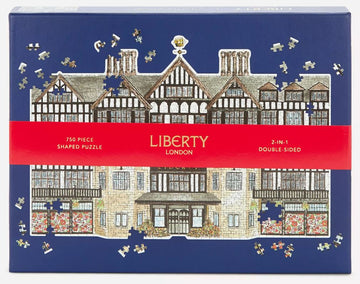 Liberty London Tudor Building jigsaw puzzle featuring a beautifully illustrated design of the iconic Tudor architecture, showcasing intricate details and colors, suitable for puzzle enthusiasts. The packaging displays a 750-piece double-sided challenging puzzle with shaped pieces.