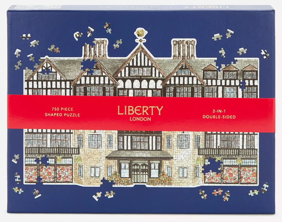 Liberty London Tudor Building jigsaw puzzle featuring a beautifully illustrated design of the iconic Tudor architecture, showcasing intricate details and colors, suitable for puzzle enthusiasts. The packaging displays a 750-piece double-sided challenging puzzle with shaped pieces.