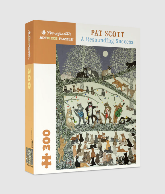 The 'A Resounding Success' jigsaw puzzle features a whimsical and colorful illustration by Pat Scott, depicting various cats in a tree adorned with lights. Designed for puzzle enthusiasts, it contains 300 pieces and promises an engaging and enjoyable experience.