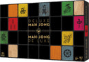 Deluxe Mahjong game box from Cardinal Games featuring traditional Mahjong tiles in bright colors. The box displays gold lettering stating 'Deluxe Mahjong' against a black background. Ideal for family game nights and players aged 8 and up.