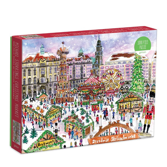 A colorful jigsaw puzzle box featuring a festive Christmas market in Dresden, depicted with a detailed illustration of market stalls, a large Christmas tree, and joyful crowds enjoying food like bratwurst. The puzzle contains 1000 pieces and is made by Galison. The artwork showcases a snowy backdrop with prominent historical buildings in different colors.