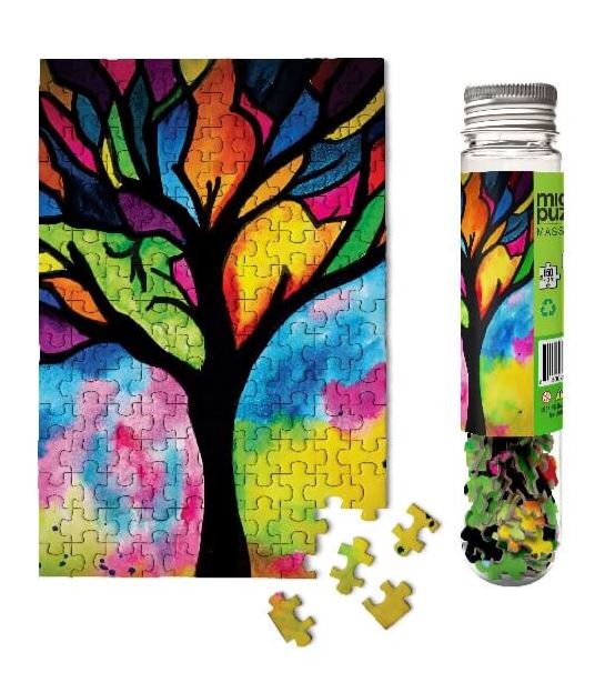 A colorful stained glass tree design jigsaw puzzle with vibrant hues of purple, blue, green, yellow, and orange. The puzzle pieces are in a glass tube, and a few puzzle pieces are scattered in front. Perfect for puzzle enthusiasts looking for a beautiful and engaging challenge.