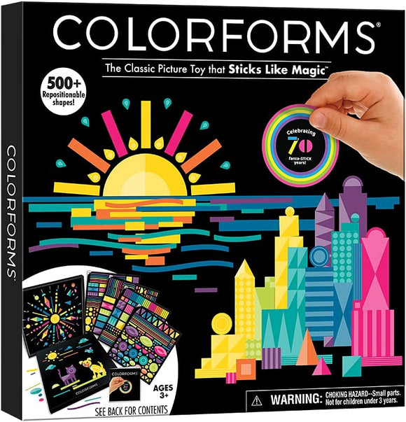 Colorforms 70th Anniversary set showcasing the classic picture toy that includes over 500 repositionable shapes. The vibrant packaging features artistic scenes of a colorful sunset over a city skyline, suitable for ages 3 and up. The hands of a child are seen interacting with one of the shapes, highlighting the interactive and creative play experience offered by this DIY kit.