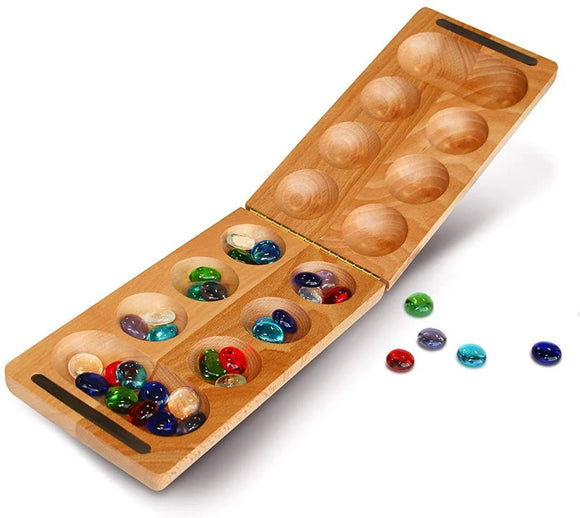 Wooden mancala board with marbles on white background