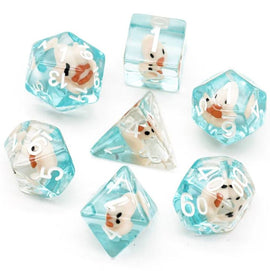 A vibrant Pink Duck RPG Dice Set by Foam Brain featuring a collection of seven unique polyhedral dice. Each die is semi-transparent blue with playful pink duck designs encapsulated within, making them perfect for tabletop gaming. The set includes various shapes, such as d4, d6, d8, d10, d12, d20, and d00 dice to enhance your gaming experience.