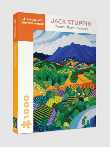 The Russian River Rhapsody jigsaw puzzle by Pomegranate features a vibrant landscape painted by Jack Stuppin. The box displays colorful fields, rolling hills, and blue skies, perfect for puzzle enthusiasts. This 1000-piece puzzle captures the beauty of nature with intricate details and rich colors.