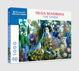 The Tamer jigsaw puzzle by Olga Suvorova, featuring a vibrant and intricate design with various animals including leopards, peacocks, and lush flowers. The box displays the title and the artist's name against a colorful backdrop.