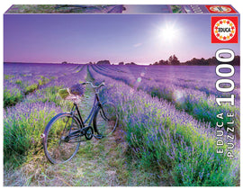 A serene jigsaw puzzle image featuring a vintage black bicycle standing on a path through a vibrant lavender field. The scene is bathed in soft sunlight, highlighting the lush purple lavender and contrasting greenery, perfect for puzzle enthusiasts who appreciate natural beauty.